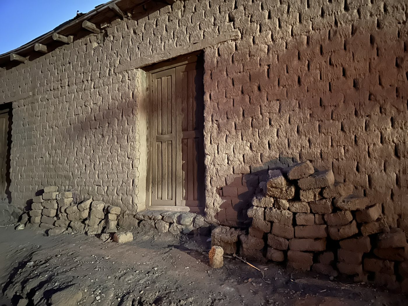 Una casa de adobe con su puerta de madera en Banda Florida, con la última luz del día